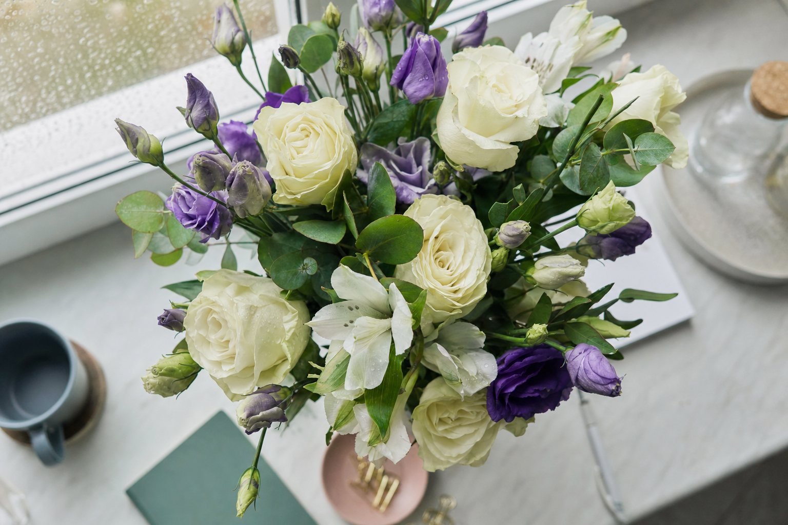 A fresh white and purple arrangement on a desk