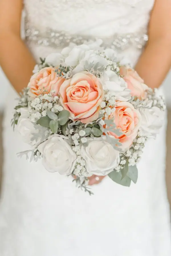 A seasonal bridal bouquet held by a bride