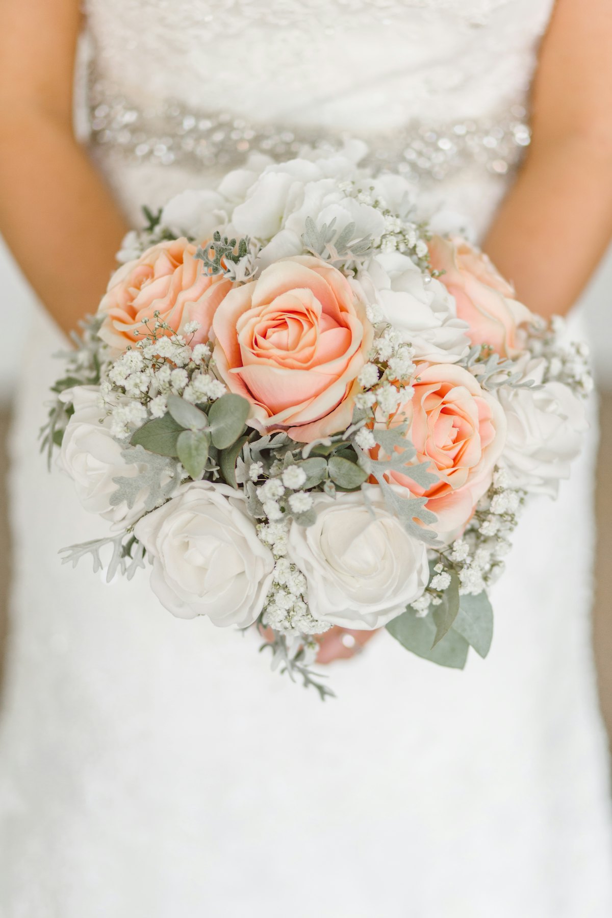 A seasonal bridal bouquet held by a bride