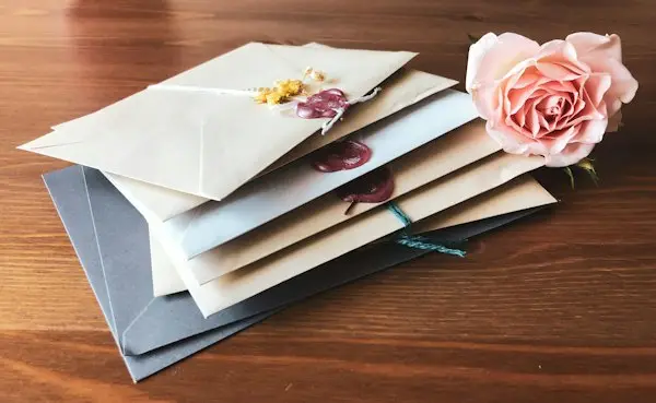 Writing a card beside fresh flowers