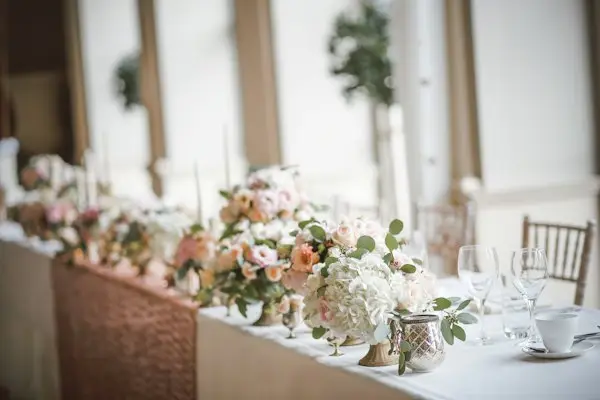 A wedding table set with floral centerpieces