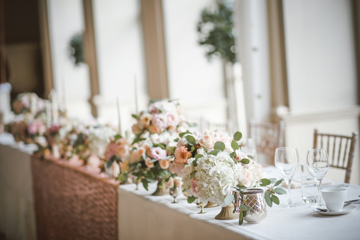 A wedding table set with floral centerpieces